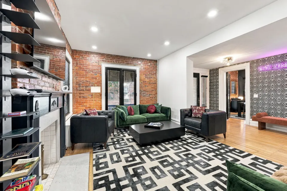 The living room around the fireplace, on a black-and-white Deco rug